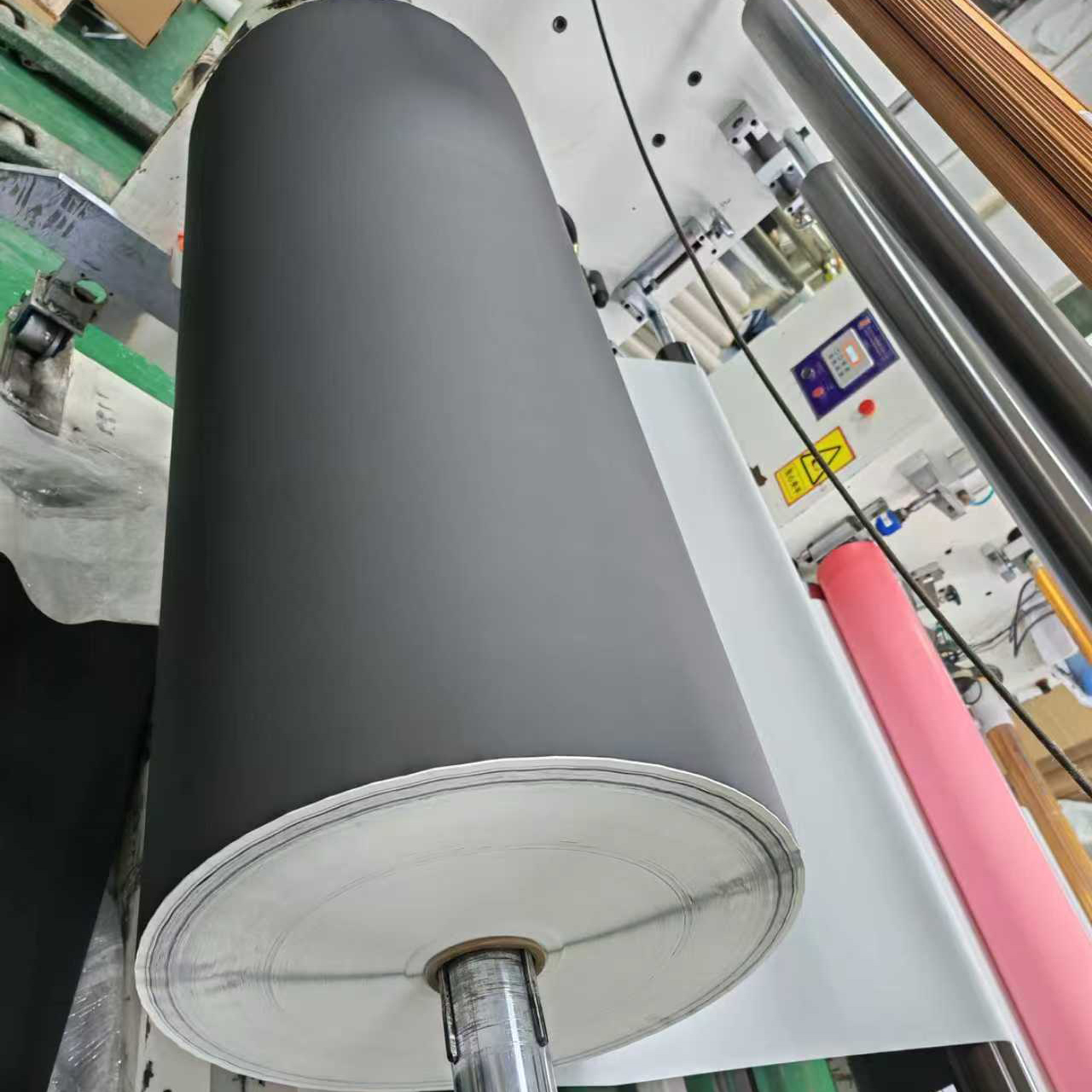 Slitting ferrous PET film to width on the slitting line